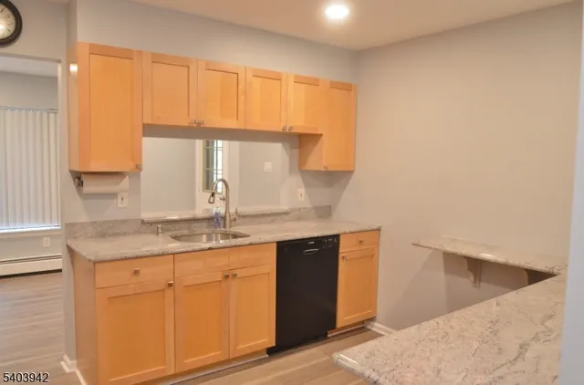 a kitchen with granite countertop a sink and a window