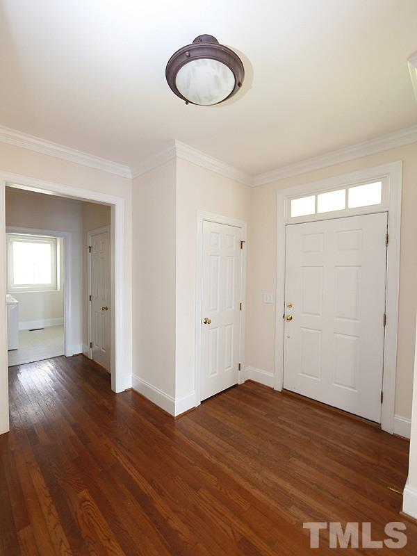 2301 Elmsford Way Raleigh, NC 27608 - Photo 8 of 25 an empty room with wooden floor and windows