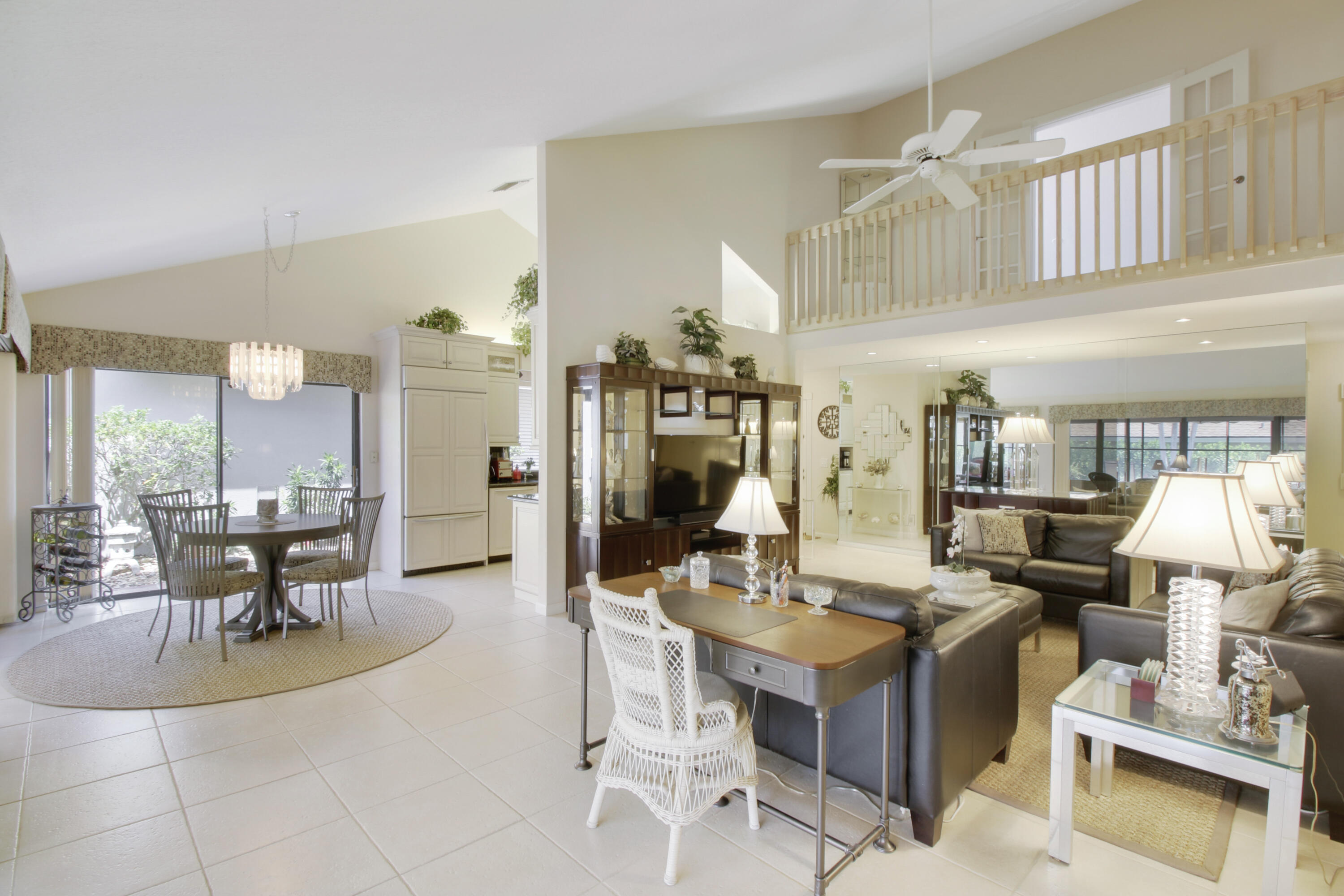 104 Harbourside Circle Jupiter, FL 33477 - Photo 15 of 41 a living room with couches a fireplace and dining table with wooden floor