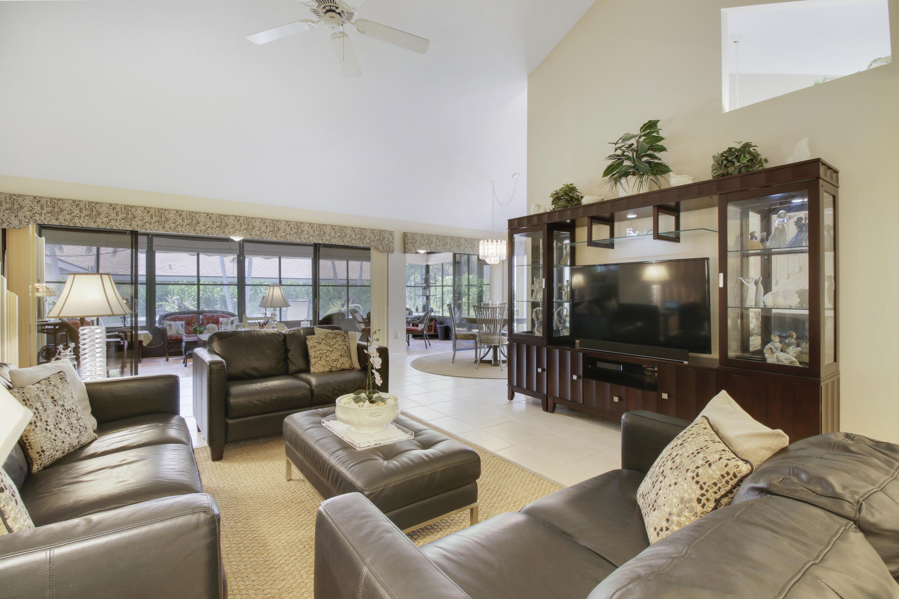 104 Harbourside Circle Jupiter, FL 33477 - Photo 18 of 41 a living room with furniture and a flat screen tv