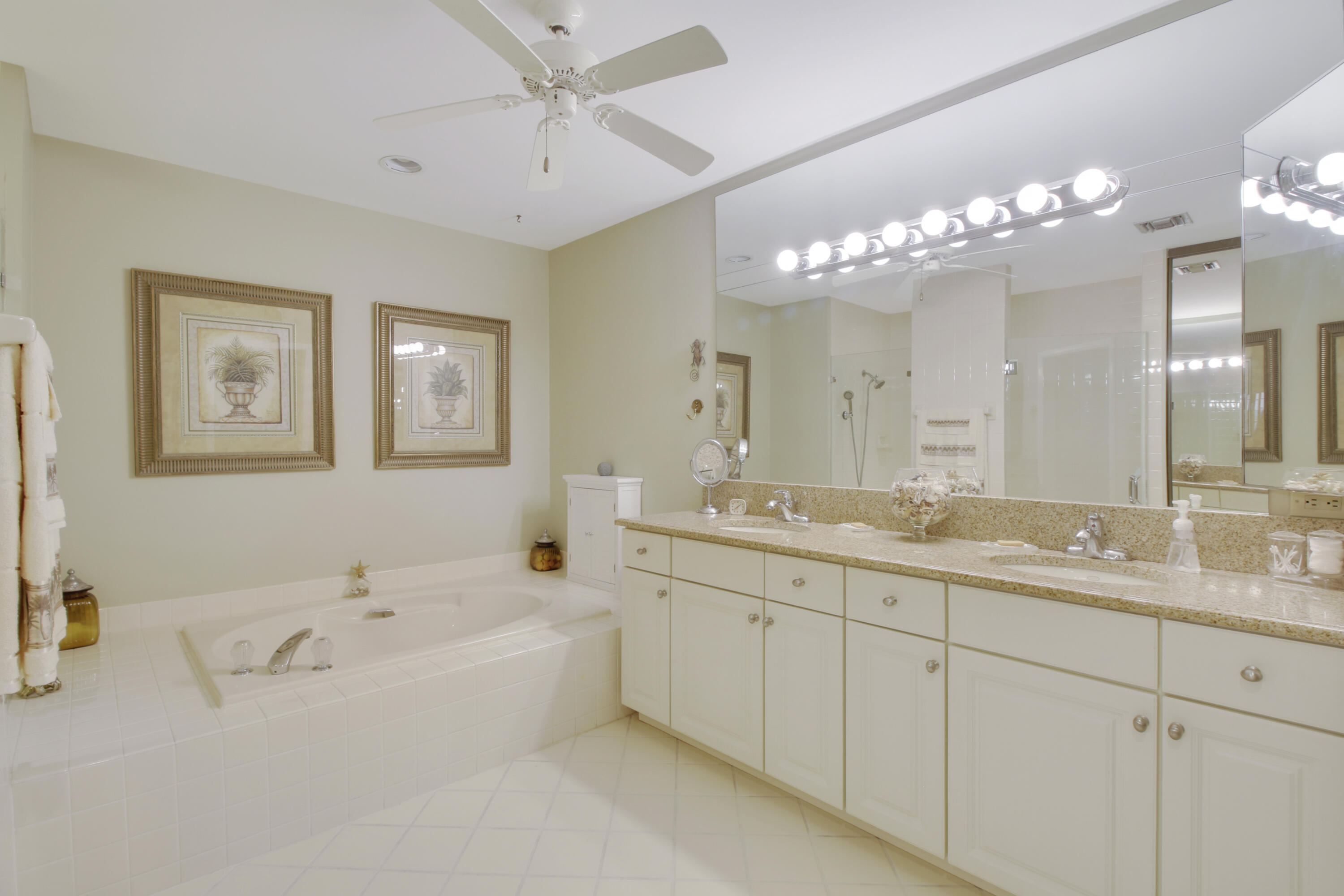 104 Harbourside Circle Jupiter, FL 33477 - Photo 21 of 41 a spacious en suite bathroom with a double vanity sink mirror and a bathtub