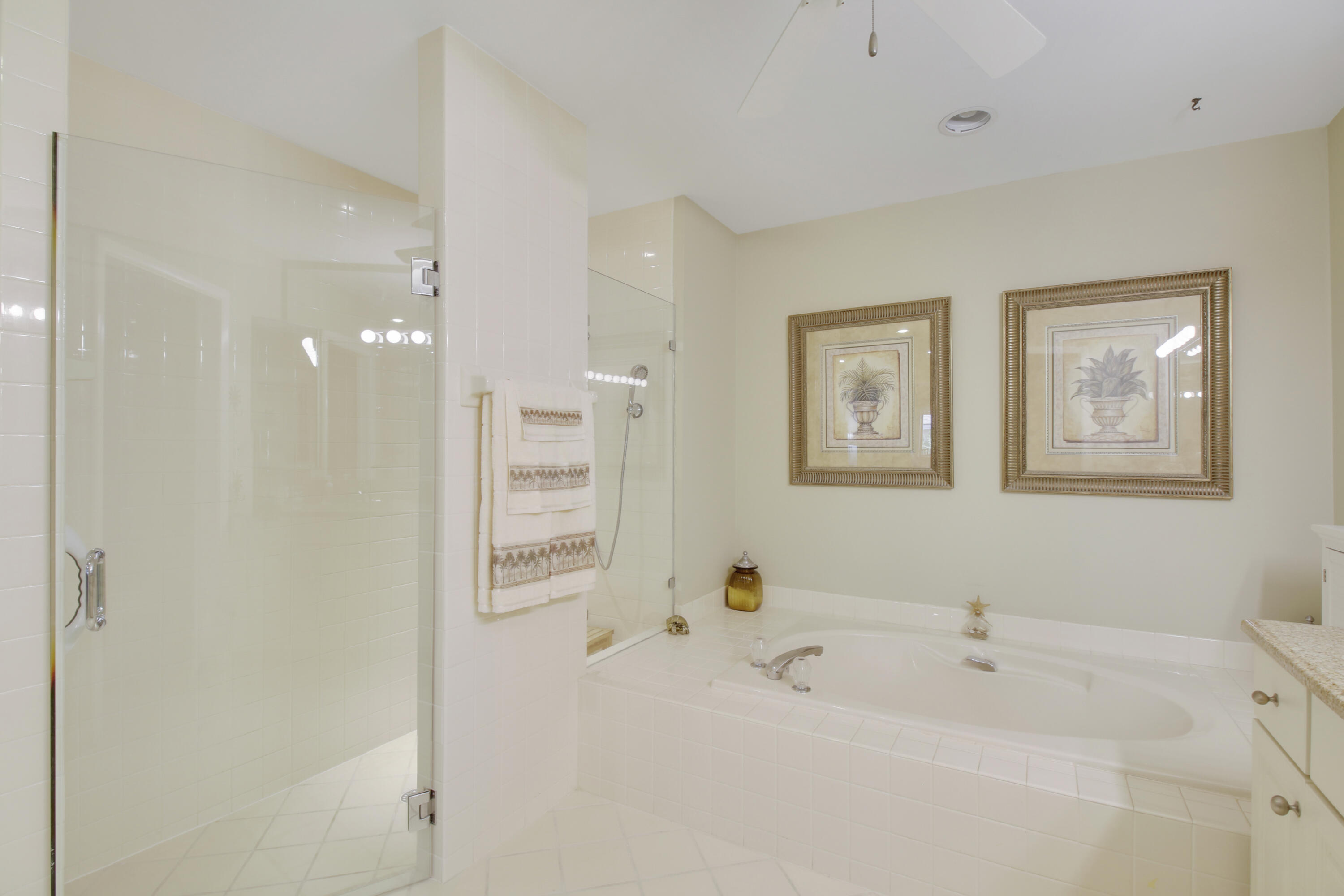 104 Harbourside Circle Jupiter, FL 33477 - Photo 22 of 41 a white bath tub sitting next to a bathroom