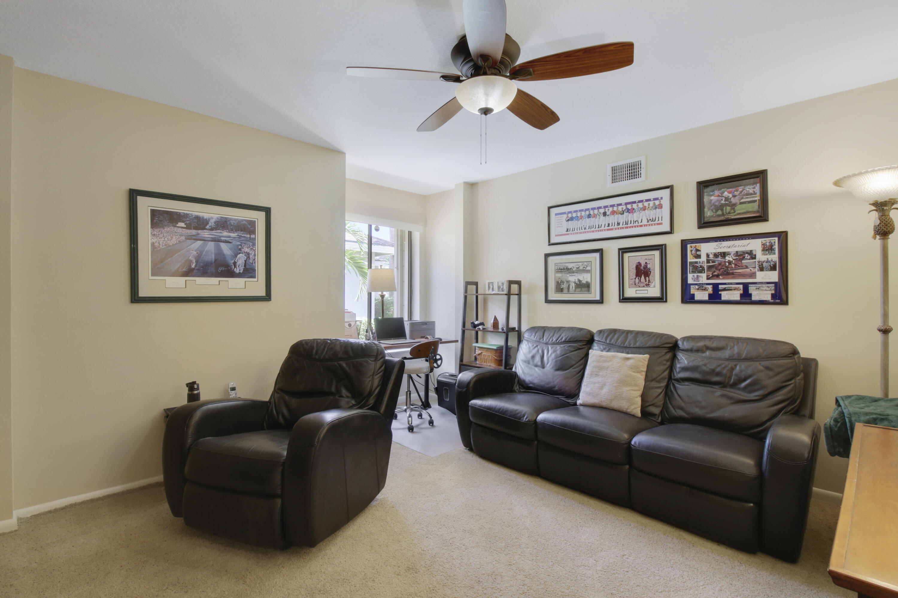 104 Harbourside Circle Jupiter, FL 33477 - Photo 25 of 41 a living room with furniture and a ceiling fan
