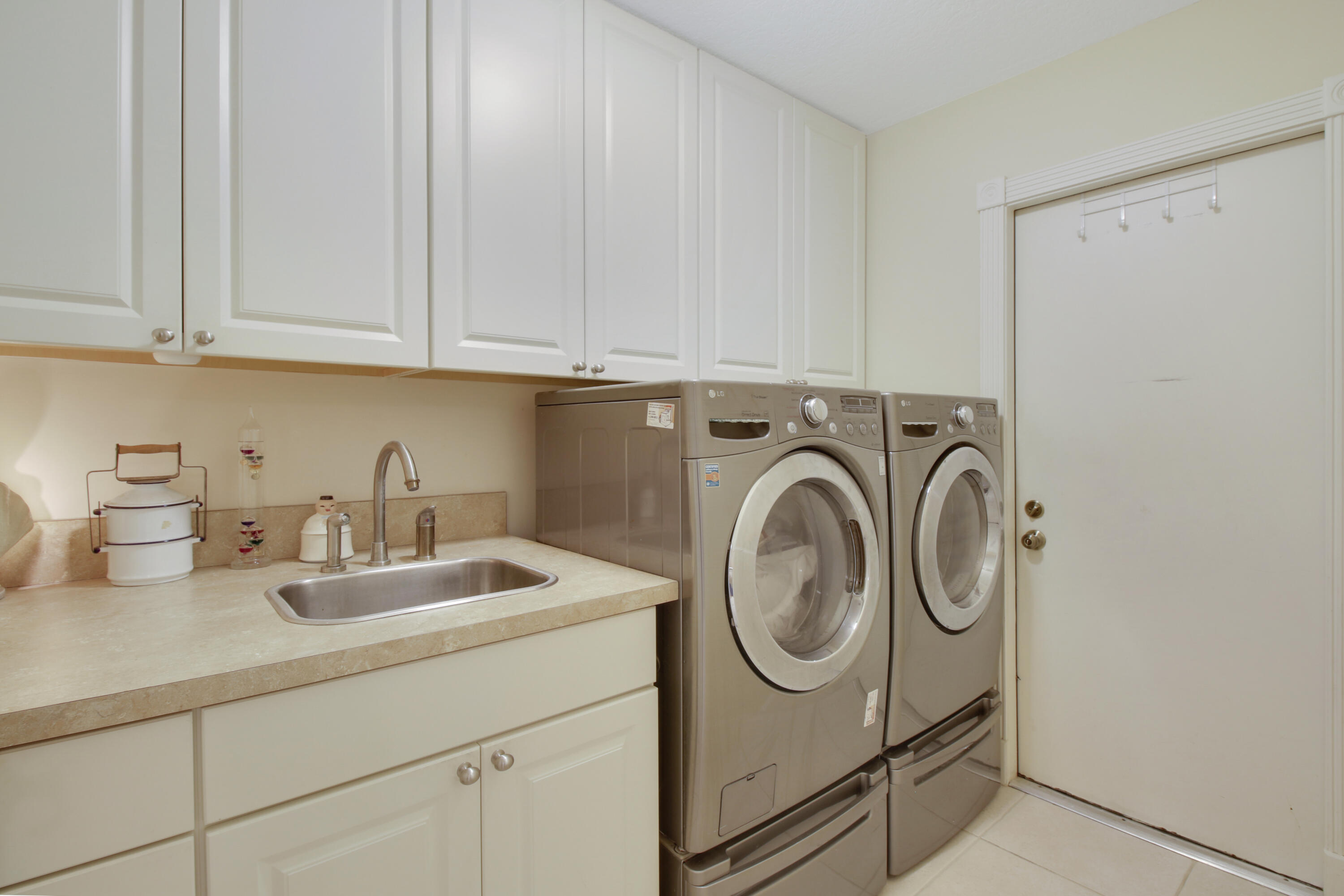 104 Harbourside Circle Jupiter, FL 33477 - Photo 28 of 41 a utility room with sink dryer and washer