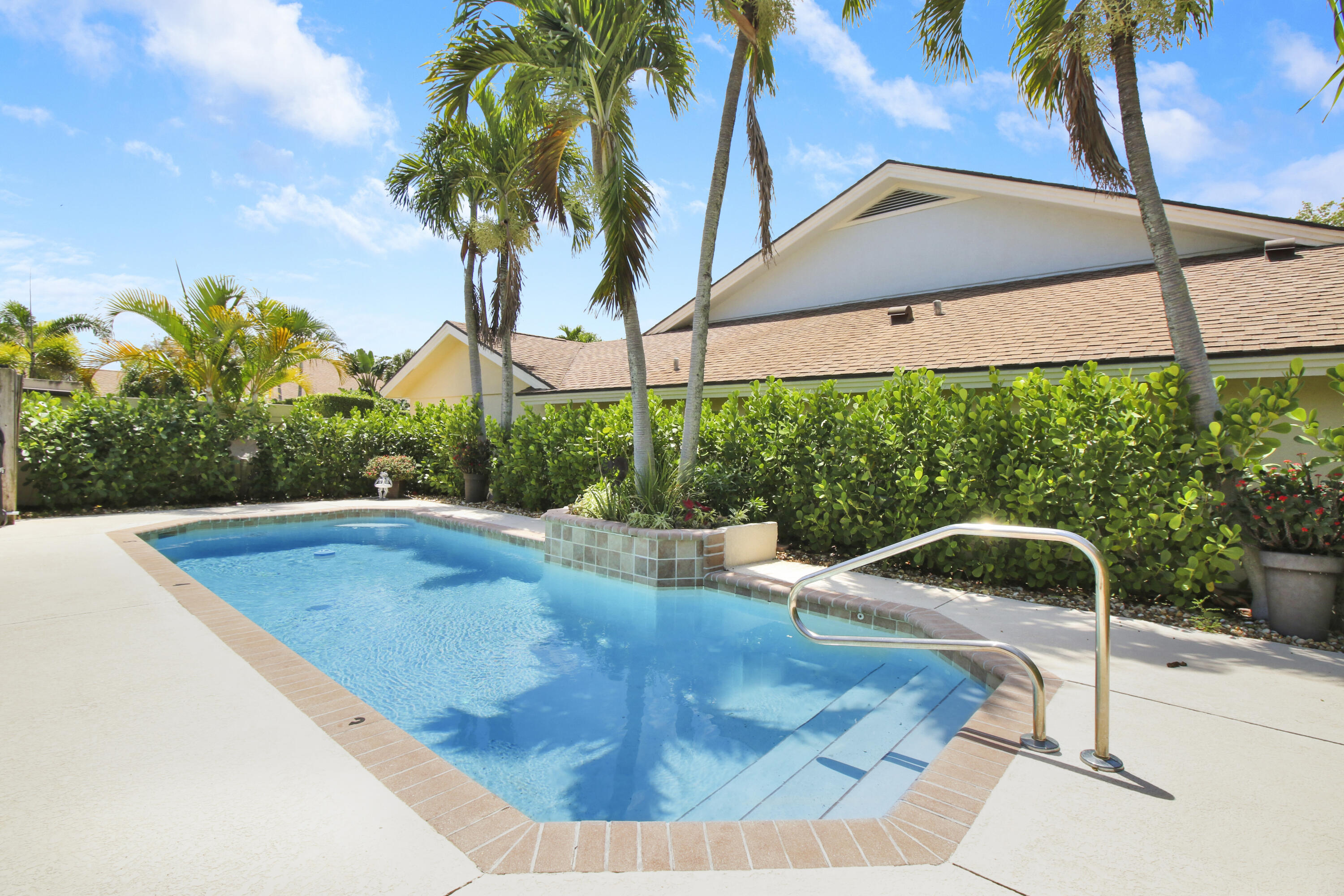 104 Harbourside Circle Jupiter, FL 33477 - Photo 33 of 41 a view of a swimming pool with a yard