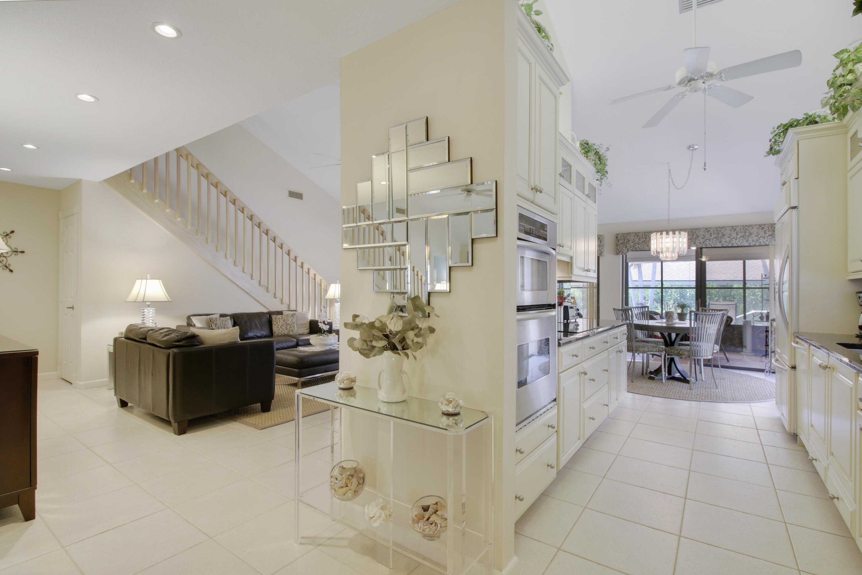 104 Harbourside Circle Jupiter, FL 33477 - Photo 7 of 41 a living room with furniture and a chandelier