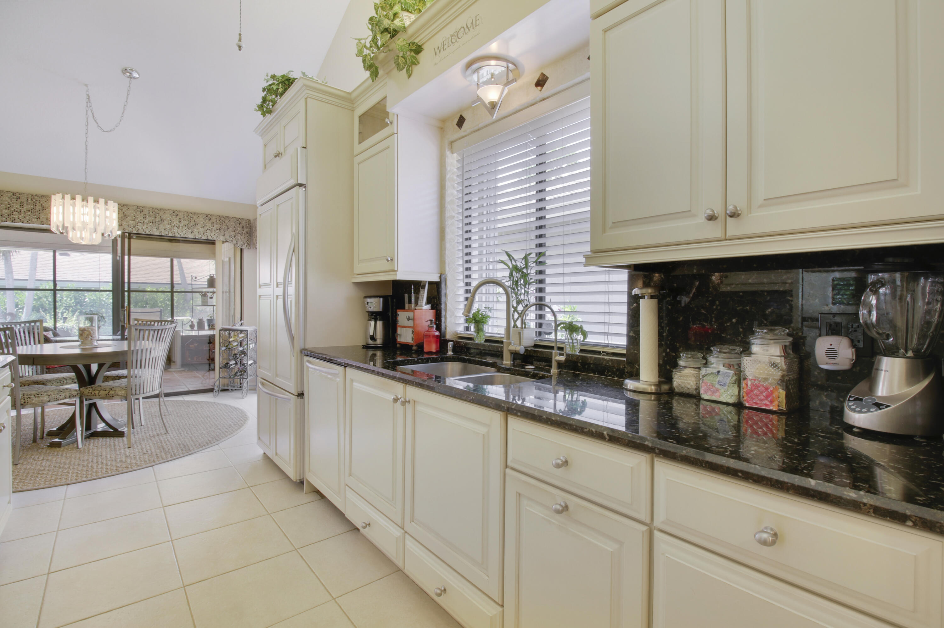 104 Harbourside Circle Jupiter, FL 33477 - Photo 8 of 41 a kitchen with granite countertop white cabinets and white appliances