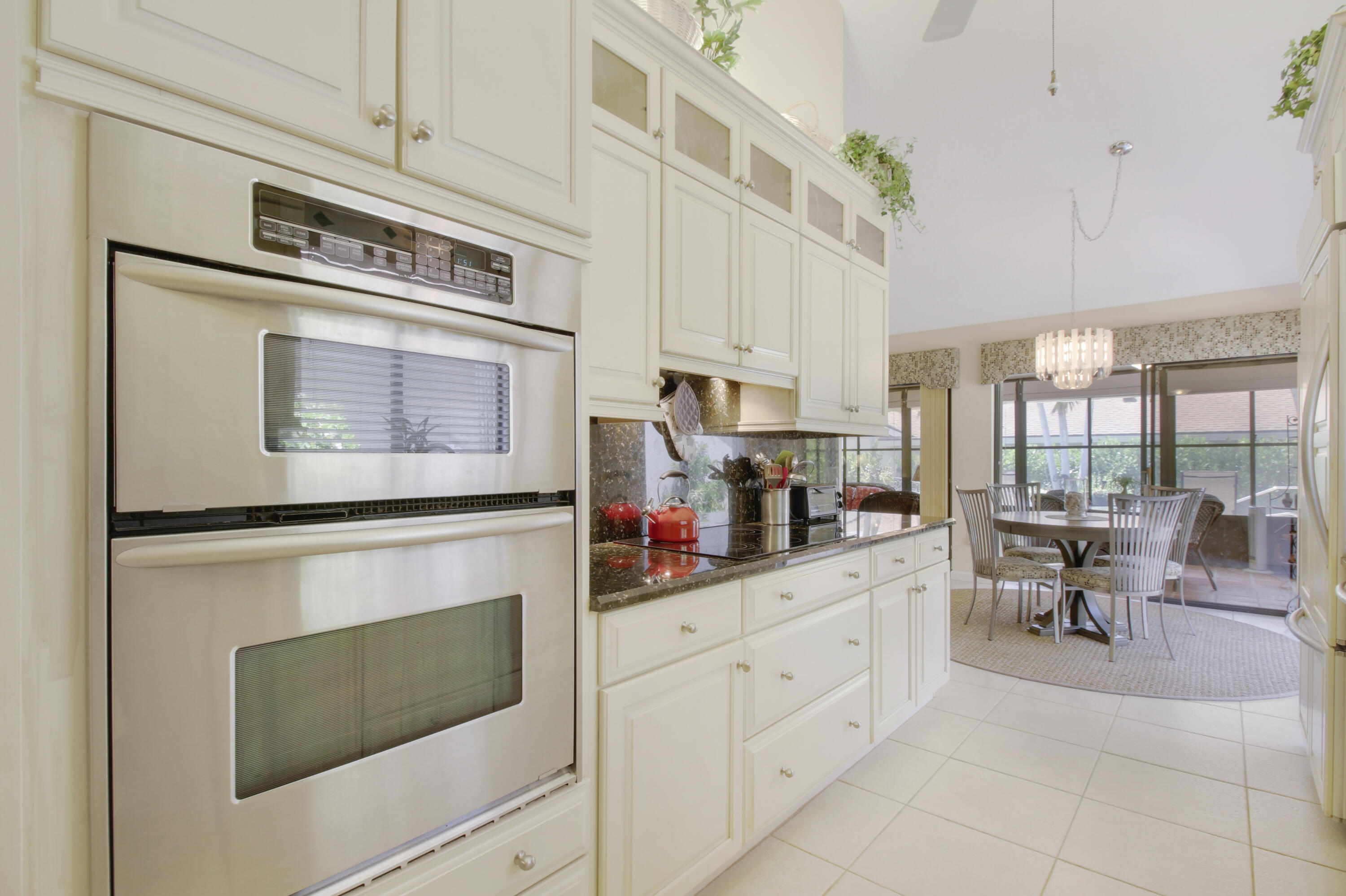 104 Harbourside Circle Jupiter, FL 33477 - Photo 9 of 41 a kitchen with stainless steel appliances a stove microwave and cabinets
