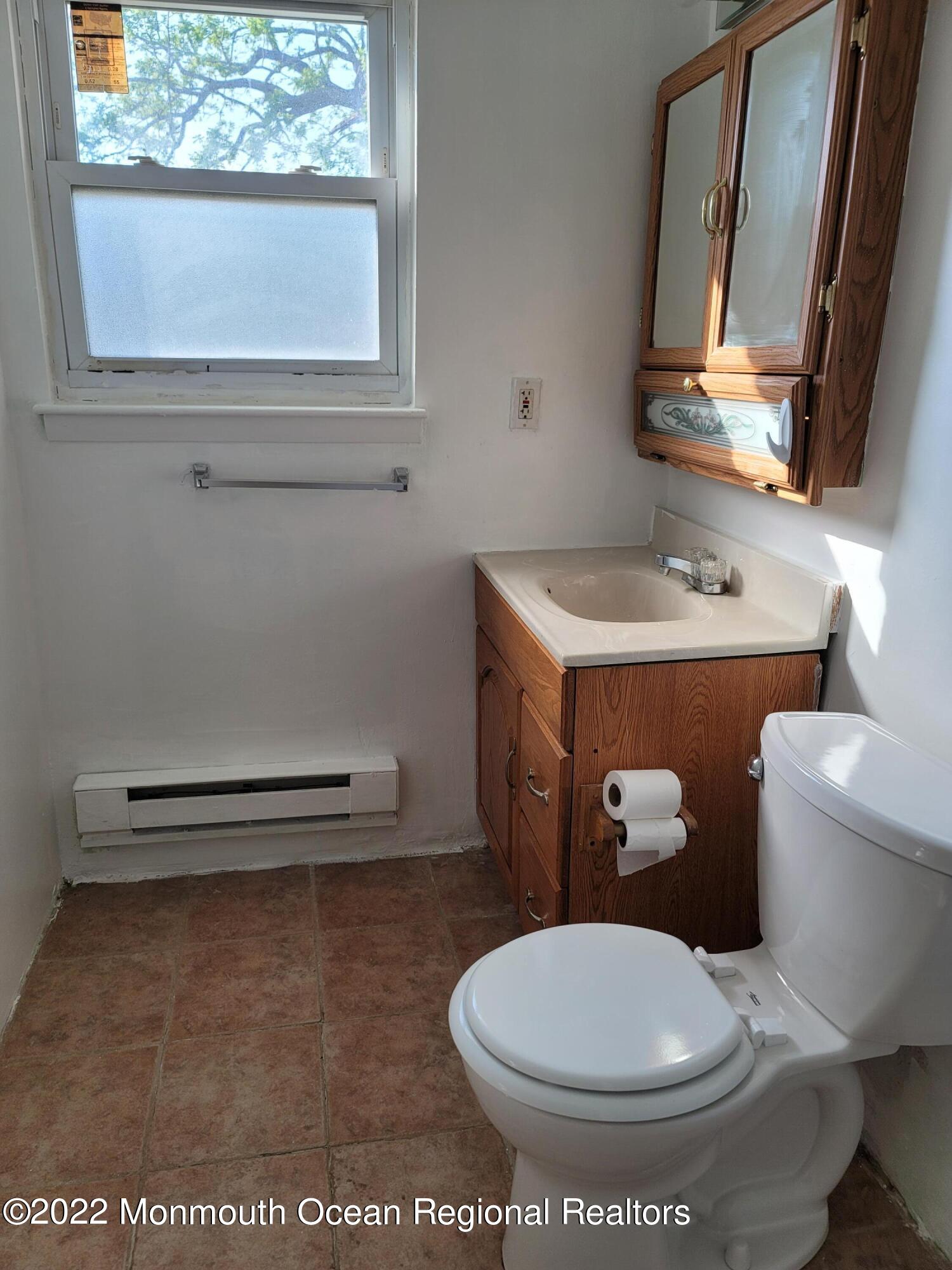 55 White Street, Unit C Eatontown, NJ 07724 - Photo 19 of 21 a bathroom with a toilet sink and mirror