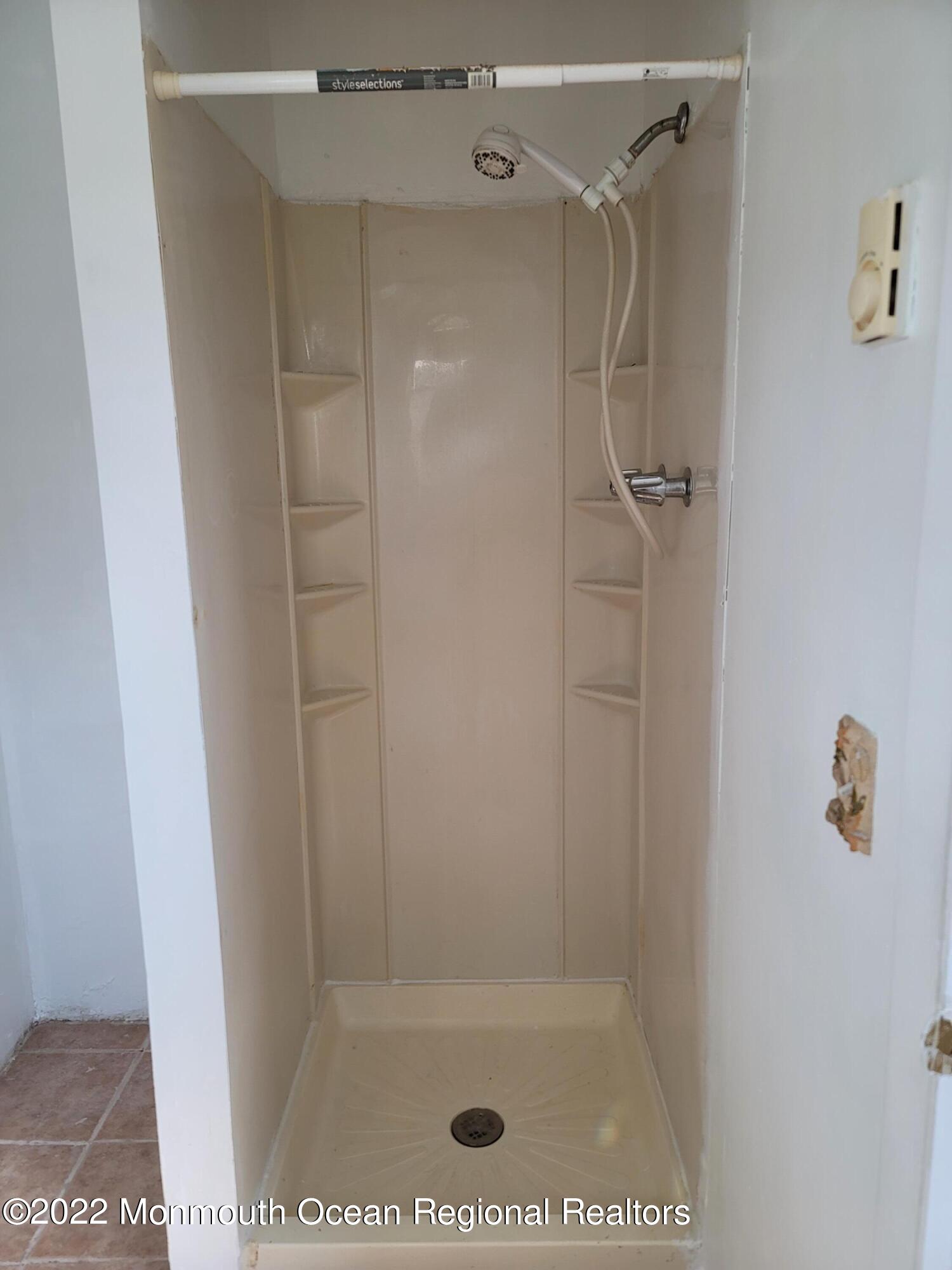 55 White Street, Unit C Eatontown, NJ 07724 - Photo 20 of 21 a bathroom with a glass shower door