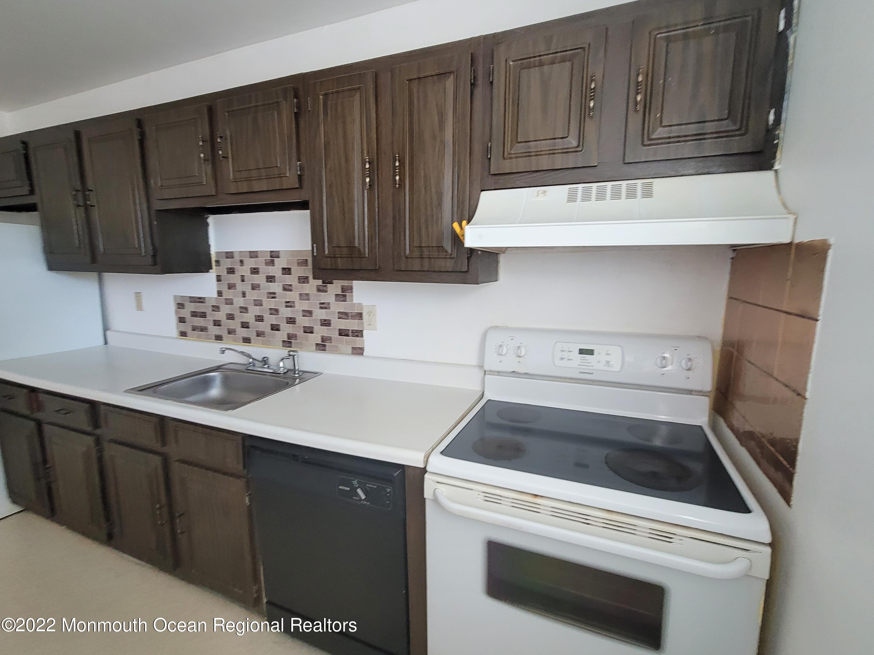 55 White Street, Unit C Eatontown, NJ 07724 - Photo 5 of 21 a kitchen with a sink stove and cabinets