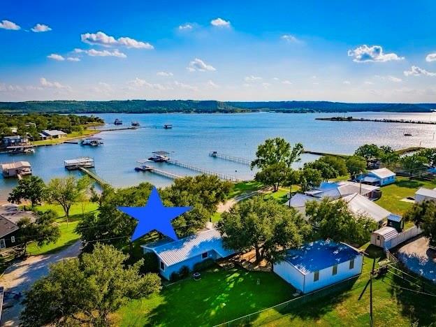 4713 Fox Hollow Road Graham, TX 76450 - Photo 2 of 39 3/2 Lakehouse, with 3 Car Garage and Double Level Dock, all with Panoramic PK Lake Views, Big Grassy Yard and Large Oak Trees for shade.