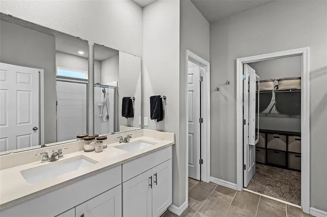 a bathroom with a double vanity sink mirror and double