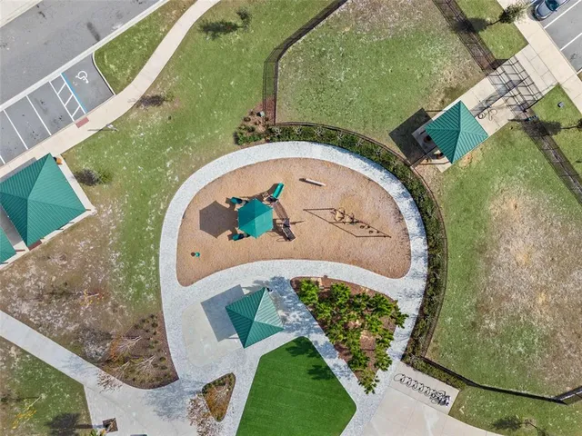 an aerial view of a house with a yard and garden