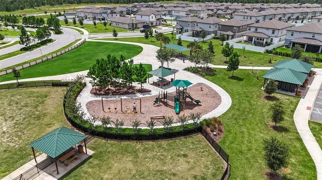 an aerial view of a house with outdoor space pool patio and lake view