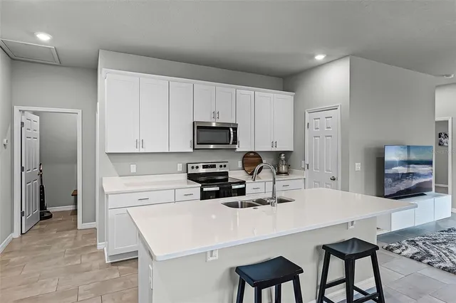a kitchen with a dining table and chairs