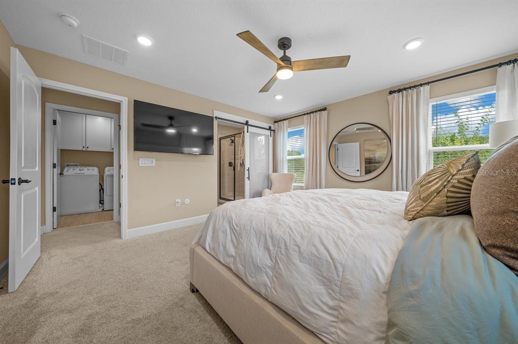 3916 Southern Vista Loop St. Cloud, FL 34772 - Photo 24 of 50 a bedroom with a large bed and a large window