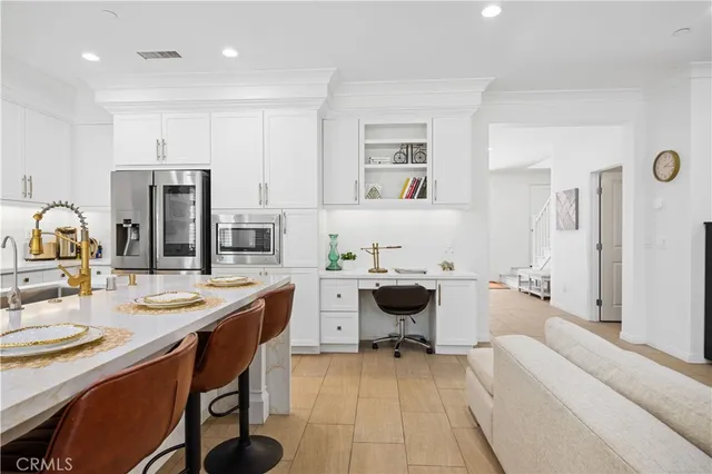 a large white kitchen with a table and chairs