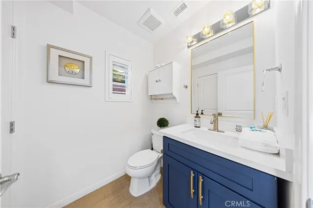 a bathroom with a sink mirror and toilet