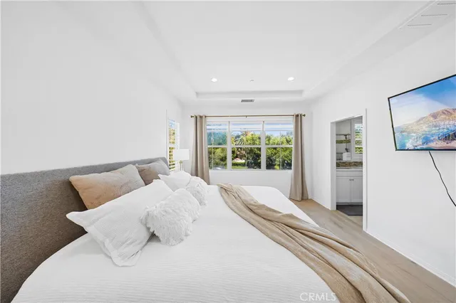 a spacious bathroom with a sink and a mirror