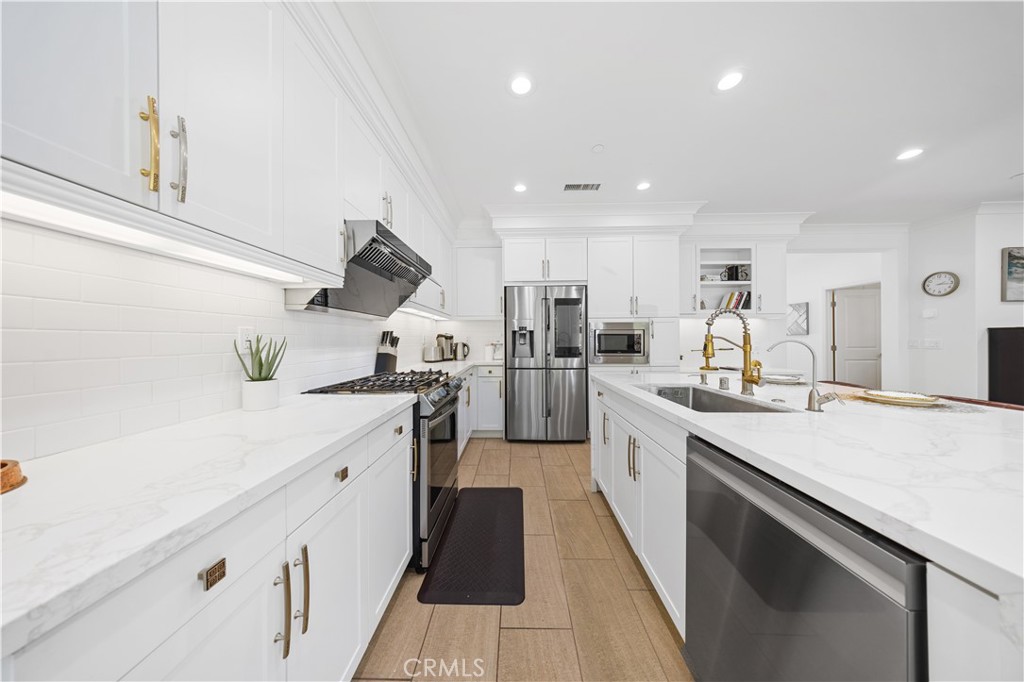 55 Rembrandt Irvine, CA 92620 - Photo 7 of 29 a large kitchen with stainless steel appliances kitchen island a large counter top a stove and a sink