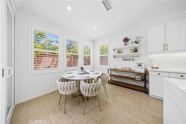 a dining room with furniture and window
