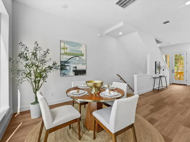 a dining room with furniture and wooden floor