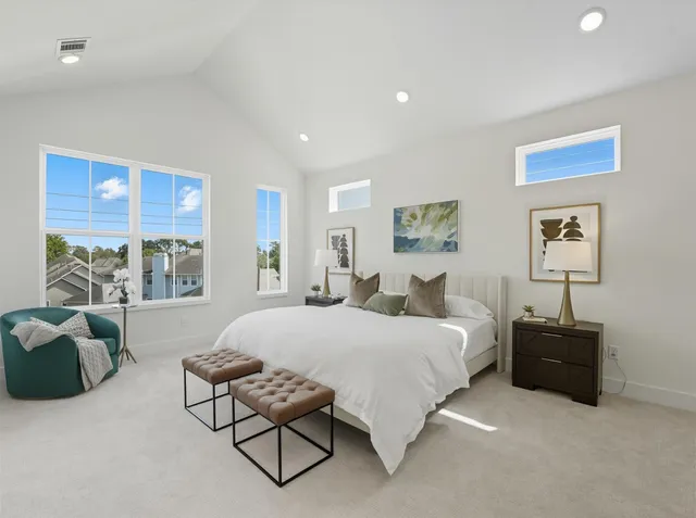 a spacious bedroom with a bed and glass window