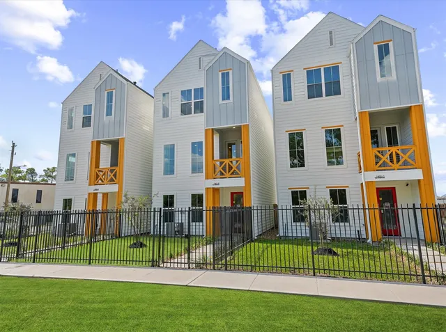 a front view of a house with a garden and plants