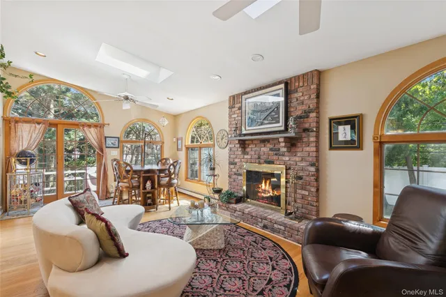 a living room with furniture fireplace and a large window