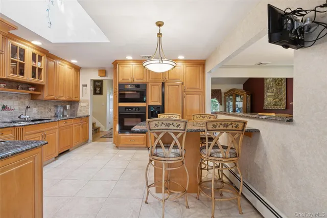 a view of a kitchen with granite countertop a window and stainless steel appliances