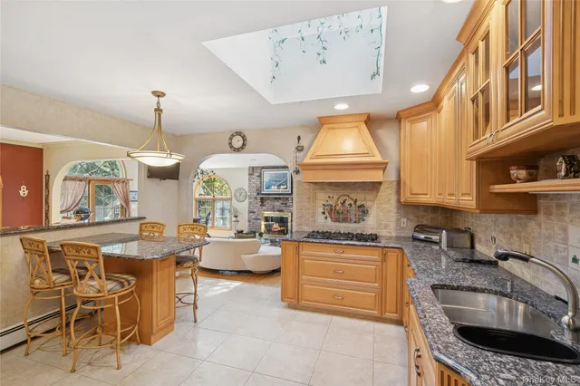 a kitchen with a stove a sink and a refrigerator