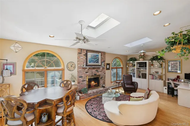 a living room with fireplace furniture and a wooden floor
