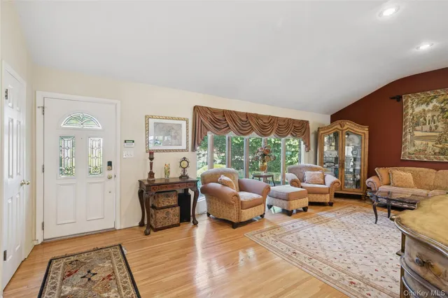 a living room with furniture and large windows