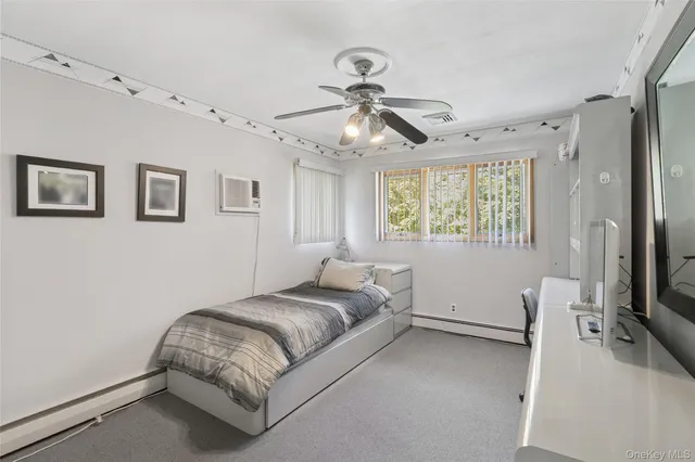 a bedroom with a bed furniture and a window