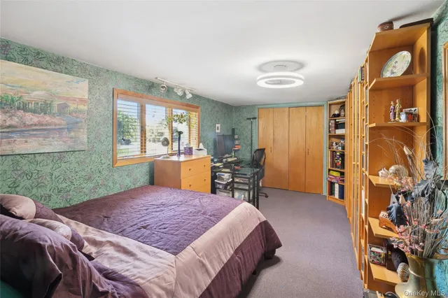 a bed sitting in a room next to a window