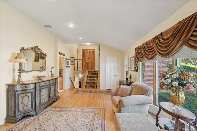 a spacious bedroom with a bed a couch and dresser