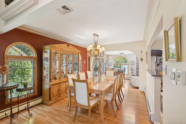 a view of a dining room with furniture window and wooden floor