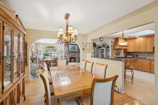 a view of a dining room with furniture and a chandelier