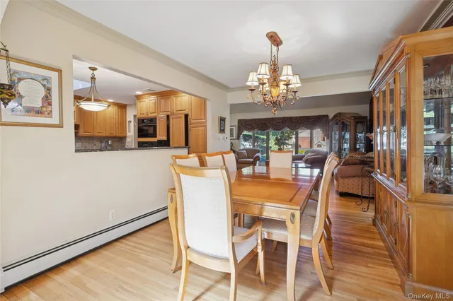 a view of a dining room with furniture wooden floor and chandelier