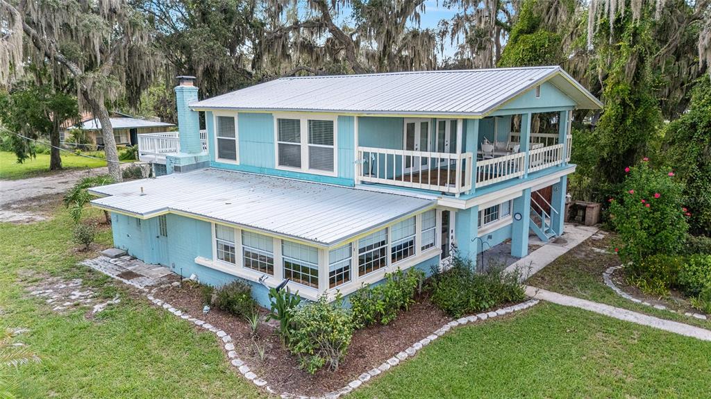 a front view of a house with a yard table and chairs