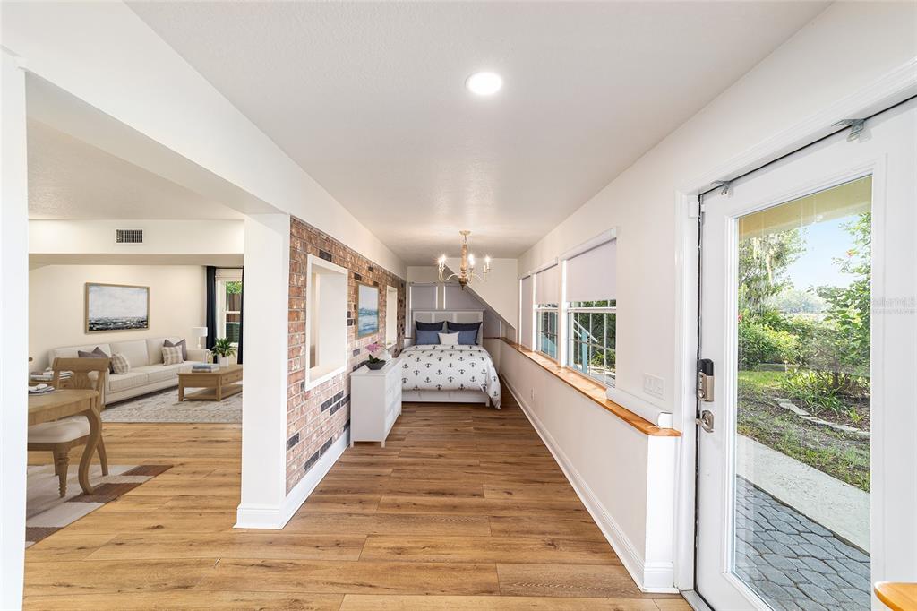 10399 Northeast 218th Lane Road Fort McCoy, FL 32134 - Photo 11 of 68 a view of a hallway view with floor to ceiling window and wooden floor