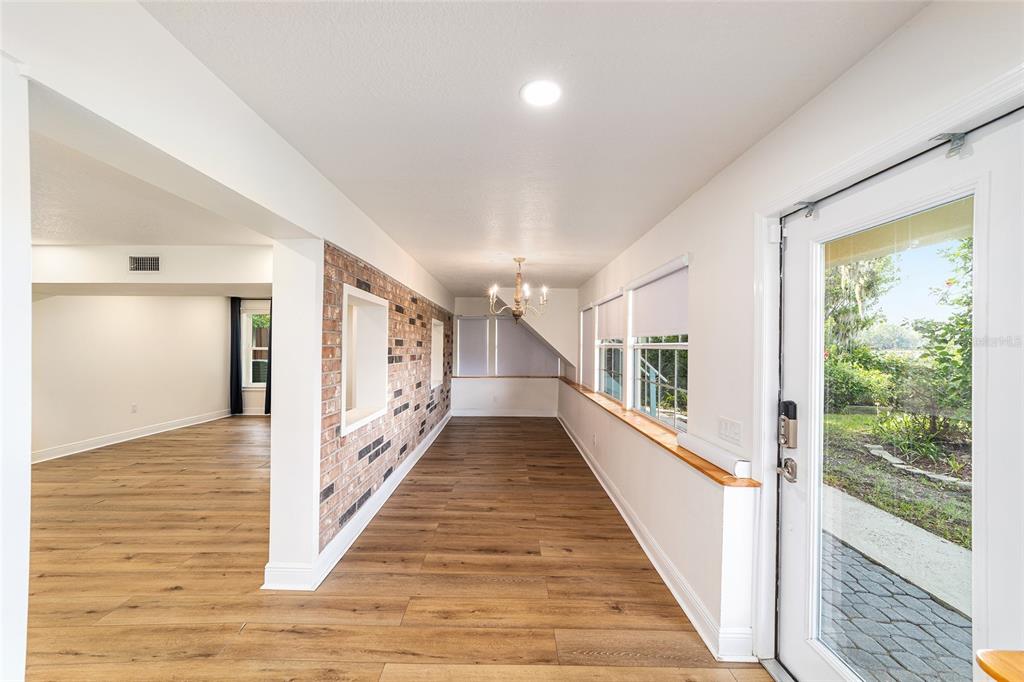 10399 Northeast 218th Lane Road Fort McCoy, FL 32134 - Photo 12 of 68 a view of a hallway with wooden floor and staircase
