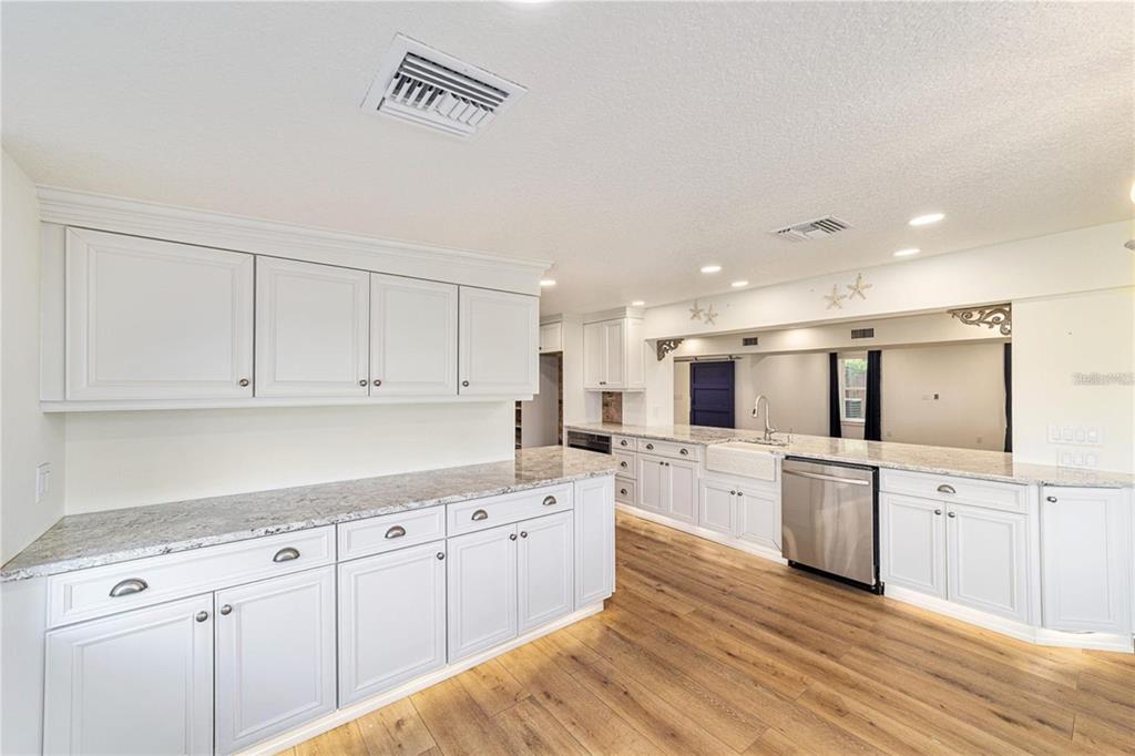 10399 Northeast 218th Lane Road Fort McCoy, FL 32134 - Photo 17 of 68 a kitchen with white cabinets and white appliances