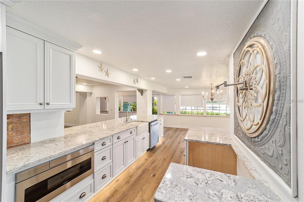 10399 Northeast 218th Lane Road Fort McCoy, FL 32134 - Photo 20 of 68 a large white kitchen with stainless steel appliances granite countertop a stove and a sink with large countertops