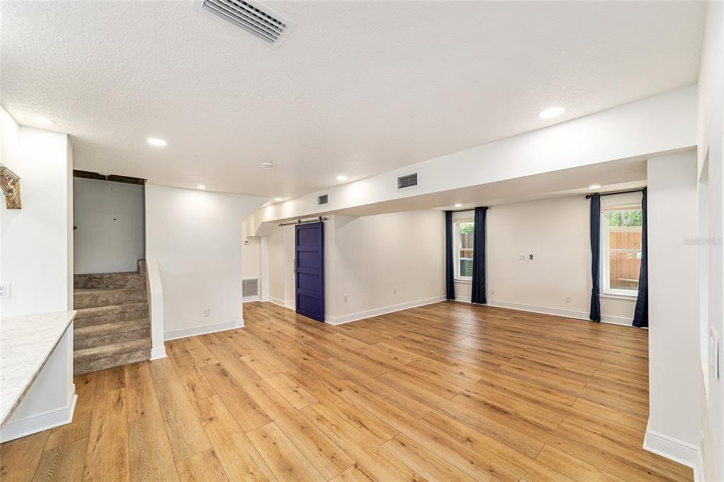 10399 Northeast 218th Lane Road Fort McCoy, FL 32134 - Photo 26 of 68 a view of an empty room with wooden floor and a window