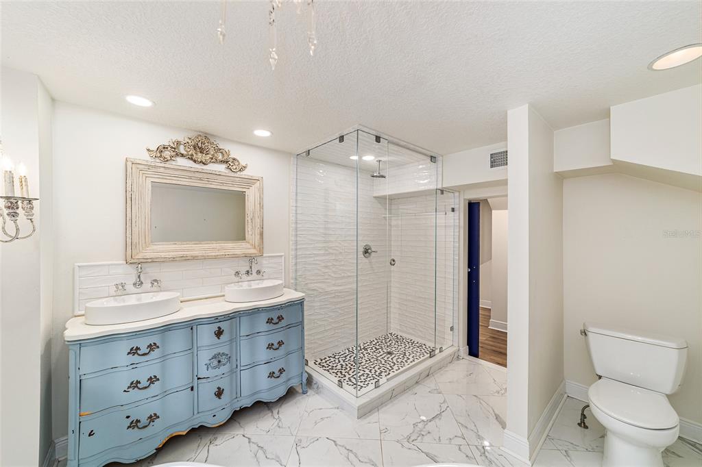 10399 Northeast 218th Lane Road Fort McCoy, FL 32134 - Photo 34 of 68 a spacious bathroom with a double vanity sink mirror and toilet