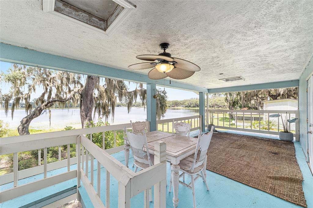 10399 Northeast 218th Lane Road Fort McCoy, FL 32134 - Photo 36 of 68 a view of a dining room with furniture large windows and wooden floor