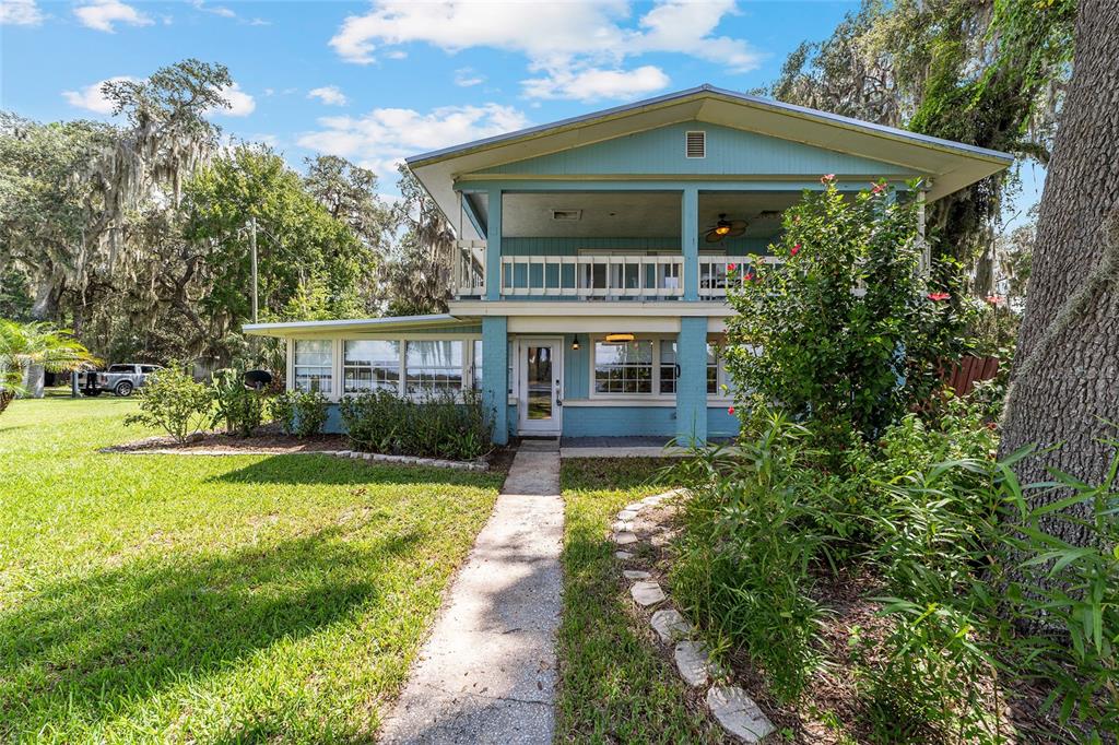 10399 Northeast 218th Lane Road Fort McCoy, FL 32134 - Photo 4 of 68 a front view of house with yard and green space
