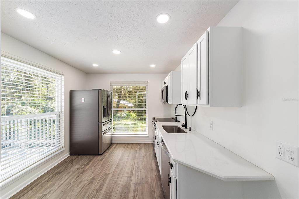 10399 Northeast 218th Lane Road Fort McCoy, FL 32134 - Photo 44 of 68 a kitchen with stainless steel appliances a refrigerator and a sink